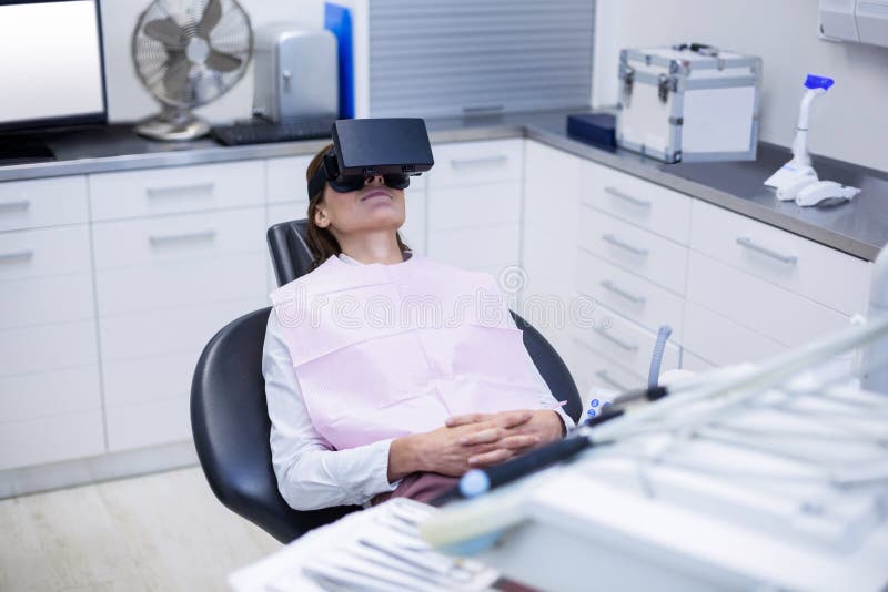 Female Patient Using Virtual Reality Headset during a Dental Visit