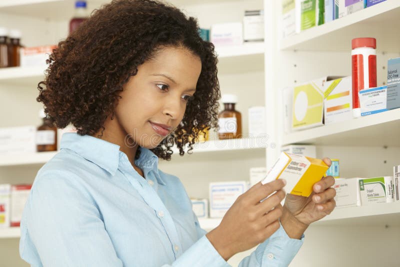 Female pharmacist working in UK pharmacy stock photo Female pharmacist working in UK pharmacy stock photo