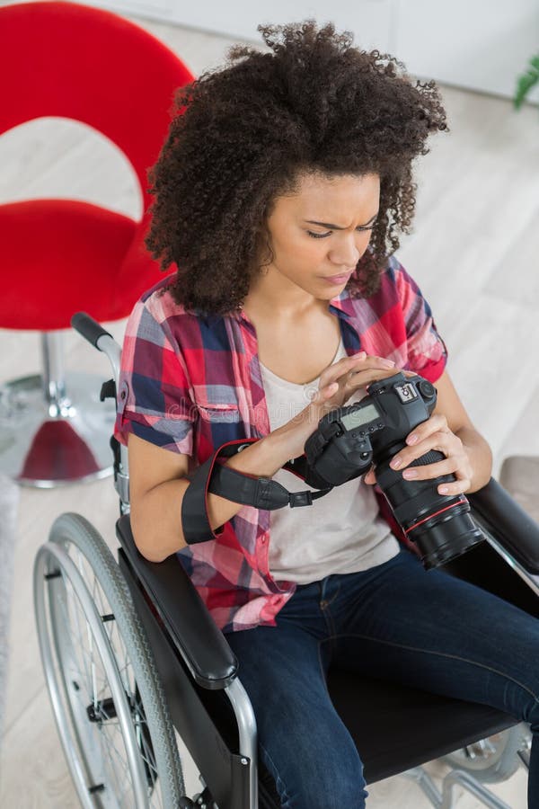 Female photographer on wheelchair using mirrorless camera royalty free stock photos Female photographer on wheelchair using mirrorless camera royalty free stock photos