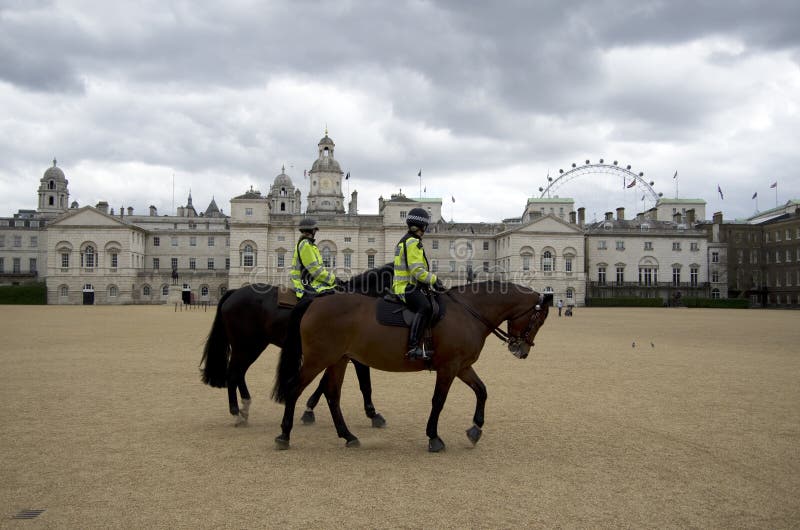 Female police riding horse in London England