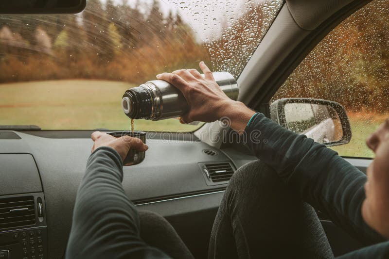 Female Pouring the Hot Tea in Tourist Thermos Mug. she Sitting on Co-driver  Seat Inside Modern Car, Enjoying the Moody Rainy Day Stock Image - Image of  relaxing, pouring: 196210855