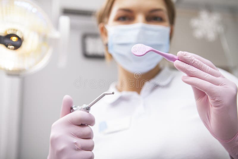 Female Professional Dentist Working at Dental Clinic Stock Photo