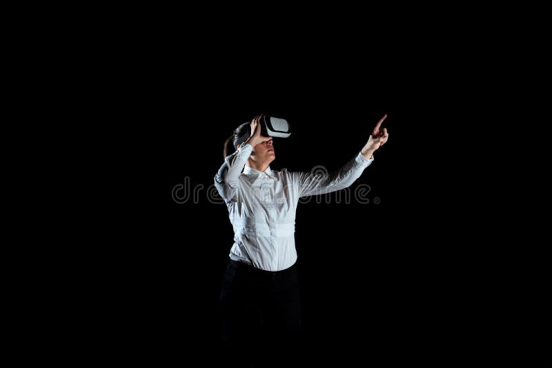 Female Professional Wearing Virtual Reality Headset Gesturing And Enjoying Simulator. Elegant Businesswoman Presenting stock photo