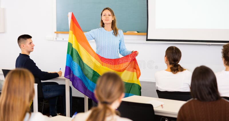 Female professor shows students rainbow flag