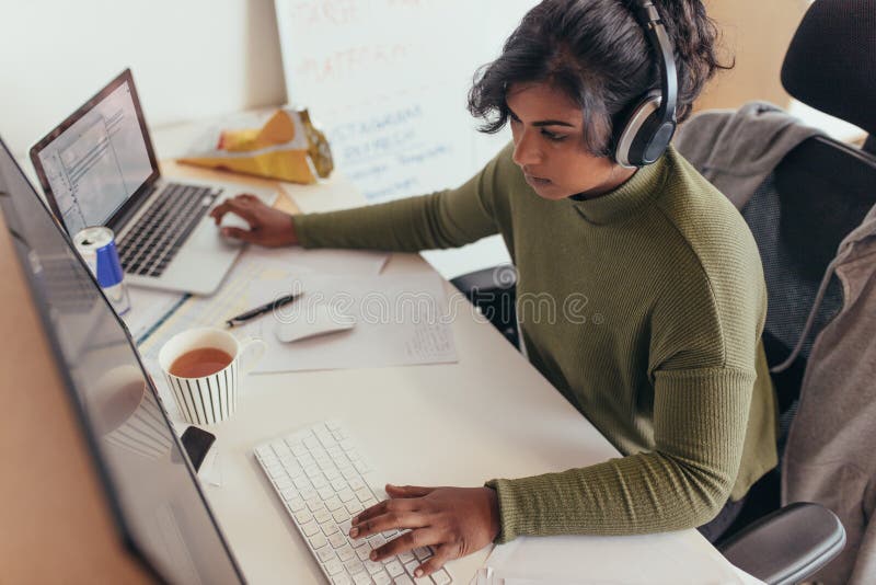 Female programmer coding on computer royalty free stock image
