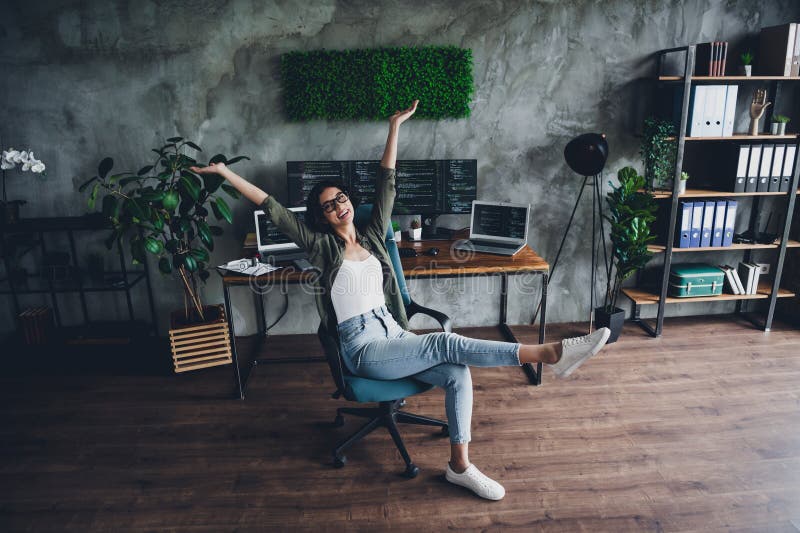 Female programmer rejoicing in stylish office space with coding screens and modern technology royalty free stock image
