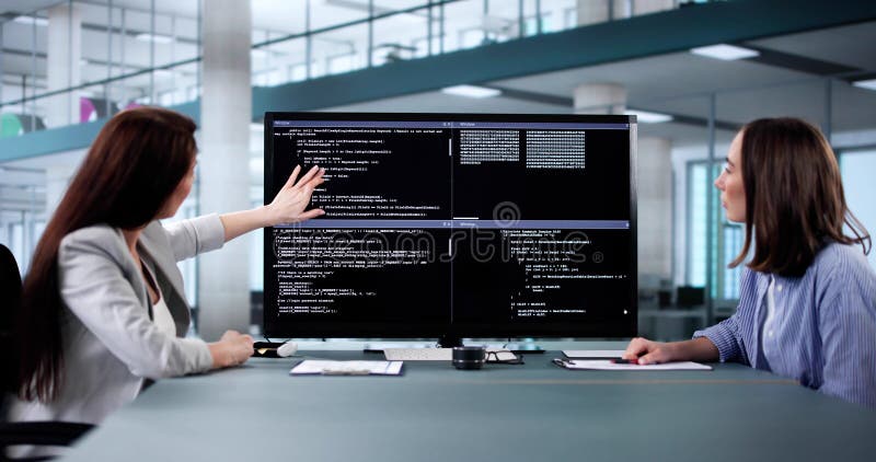 Female programmer using pair programming methodology to code software program. Software methodology stock images, royalty-free photos and pictures