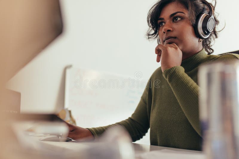 Female programmer working on computer stock image