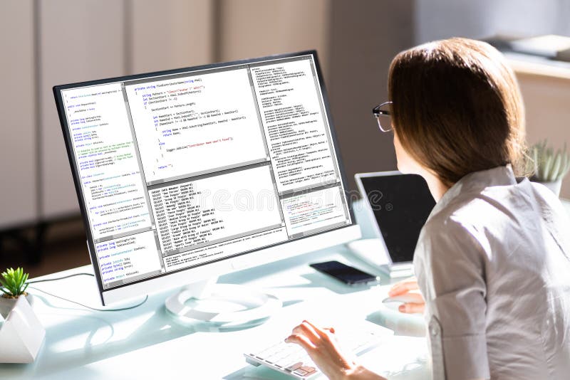 Female Programmer Working On Computer Screen stock photo