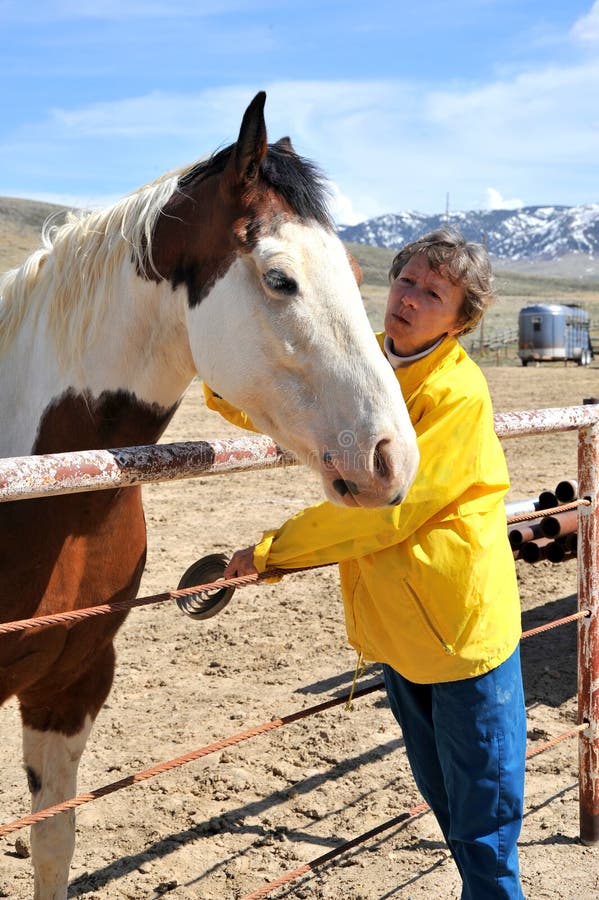 Female rancher and horse bonding.