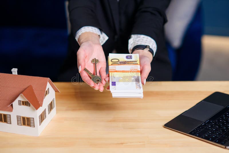 Female realtor hands with key from house and money. royalty free stock photo Female realtor hands with key from house and money. royalty free stock photo