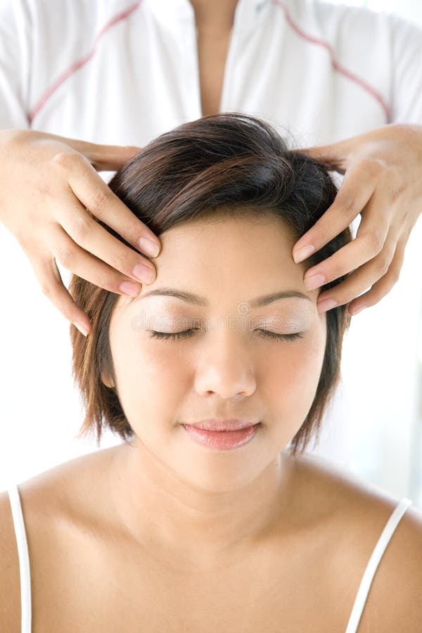 Female receiving gentle and relaxing head massage