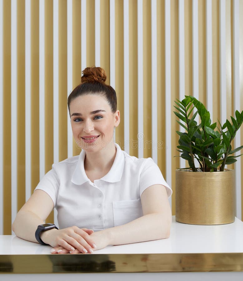 Female Receptionist at Reception Desk in a Modern Office Lobby Stock