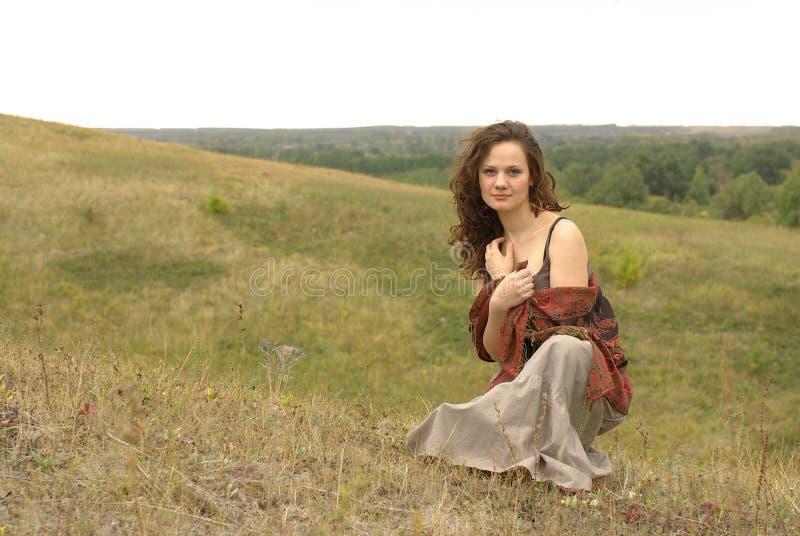 Female with a red stole sitting