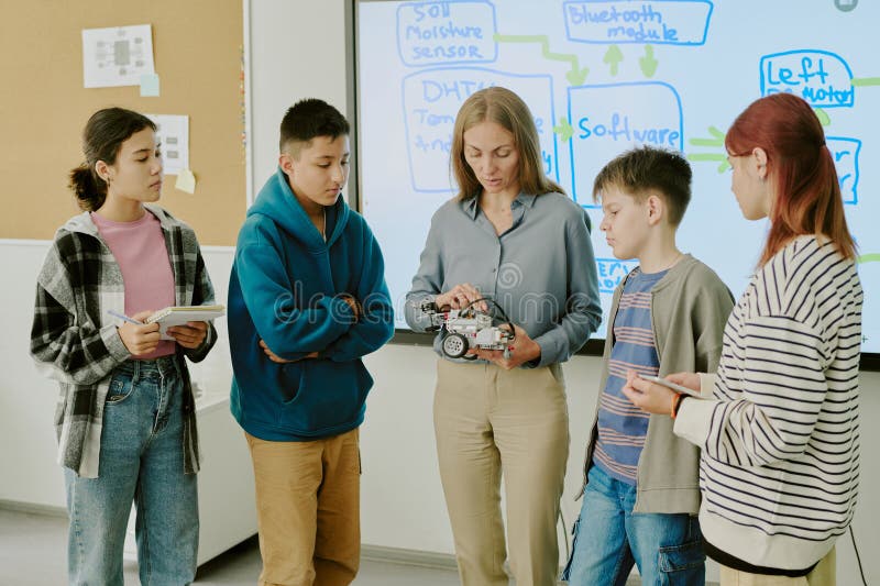 Robotics Teacher Demonstrating Robot Prototype royalty free stock images