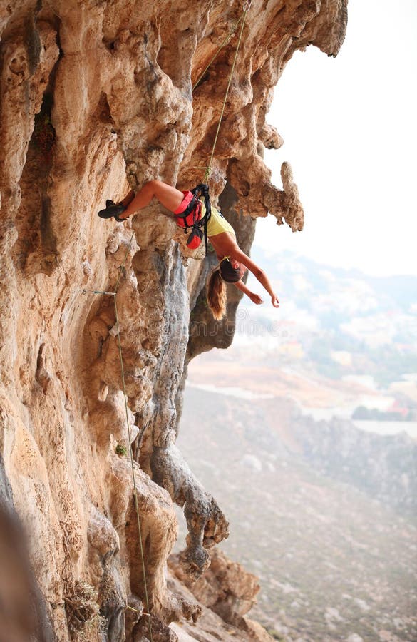 Female rock climber resting while hanging on rope stock image Female rock climber resting while hanging on rope stock image
