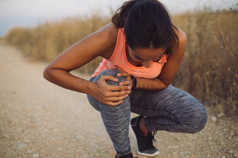 Female runner suffering from knee injury stock photography Female runner suffering from knee injury stock photography