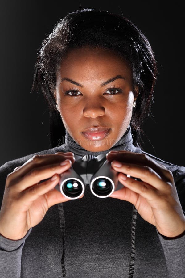 Female secret agent spy holding binoculars