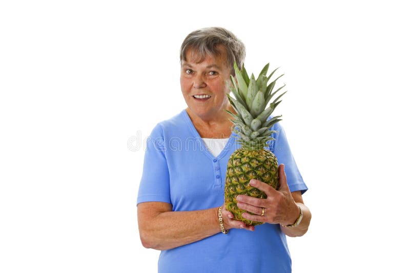 Female senior holding fresh pineapple royalty free stock photo Female senior holding fresh pineapple royalty free stock photo