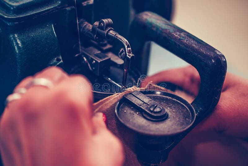 Female Hands Stitching a Part of the Shoe at a Stock Photo