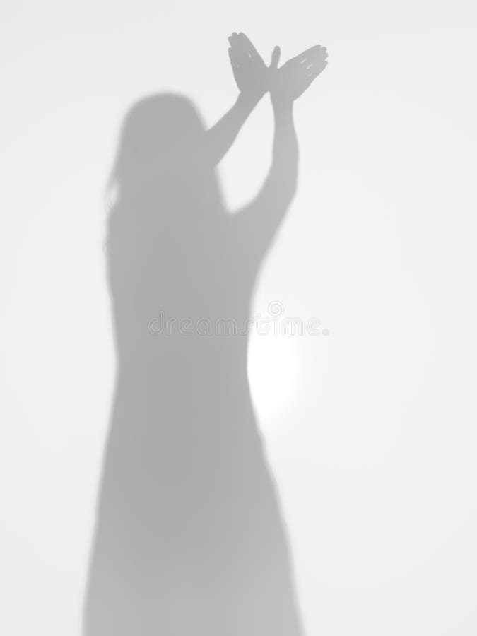 Female silhouette with hands creating a bird shape