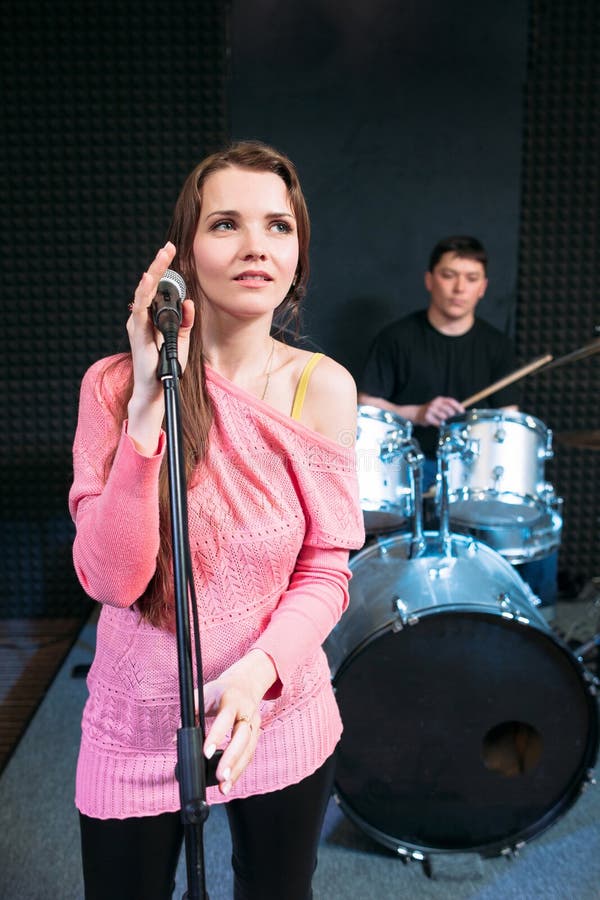 Female singer on stage holding microphone royalty free stock photo Female singer on stage holding microphone royalty free stock photo