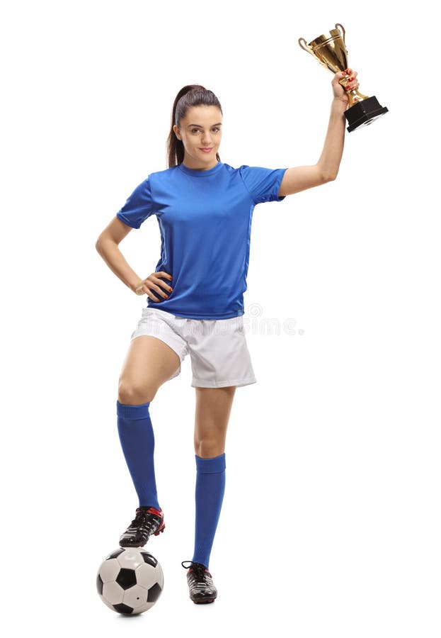 Full length portrait of a female soccer player with a football and a golden trophy isolated on white background