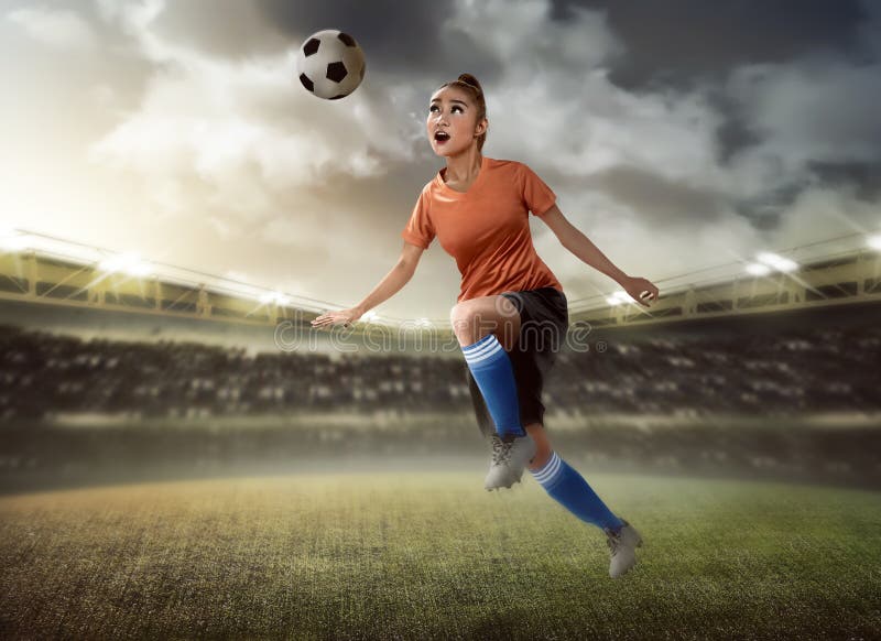 Soccer player heads ball on hi-res stock photography and images