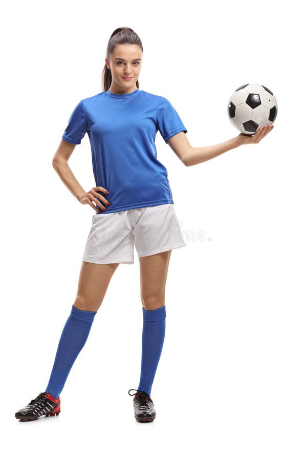 Full length portrait of a female soccer player holding a football isolated on white background