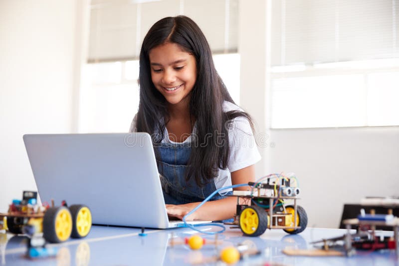 Female Student Building And Programing Robot Vehicle In After School Computer Coding Class royalty free stock images