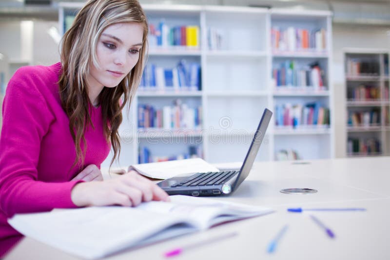 Female student with laptop and books