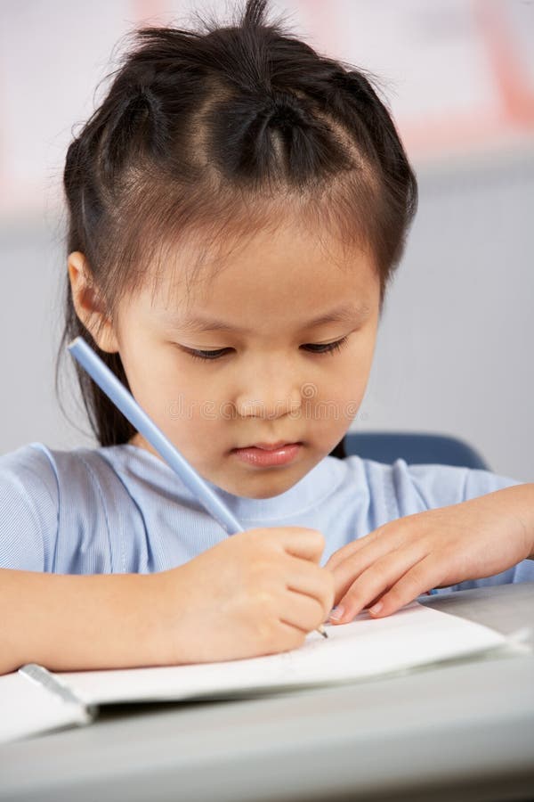 Female Student Working at Desk in Stock Photo Image of uniform, desk