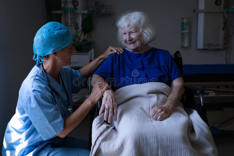 Female surgeon and senior patient talking with each other in clinic royalty free stock photo Female surgeon and senior patient talking with each other in clinic royalty free stock photo