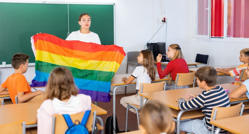 Female teacher explaining lgbt theme to children during lesson in class in secondary school