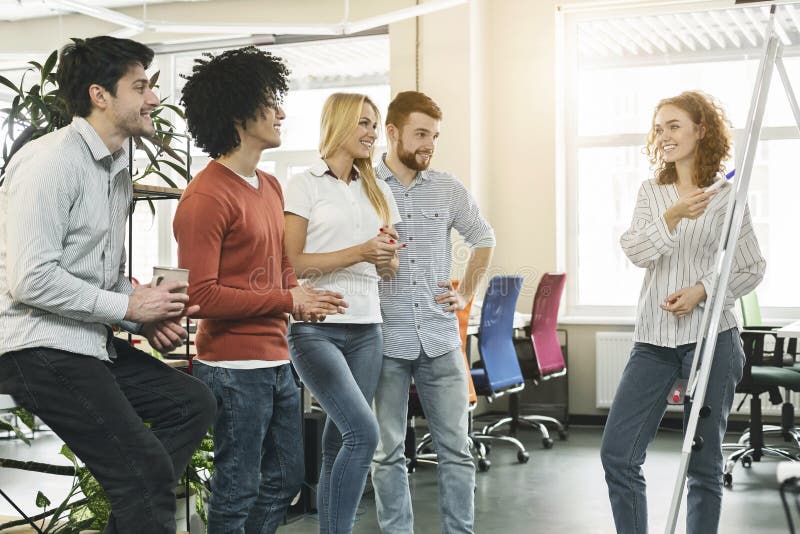 Female team leader making presentation for colleagues in office royalty free stock photo Female team leader making presentation for colleagues in office royalty free stock photo