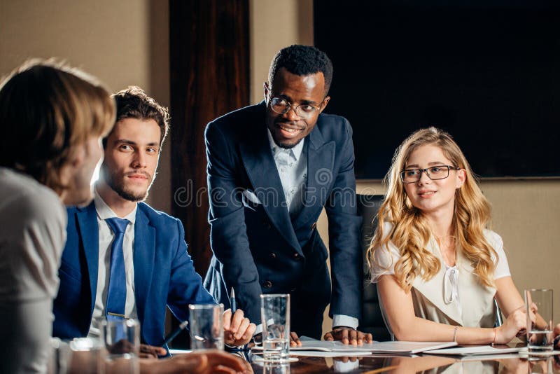 Female Team Leader Talking with Mixed Race Group of People in Office ...