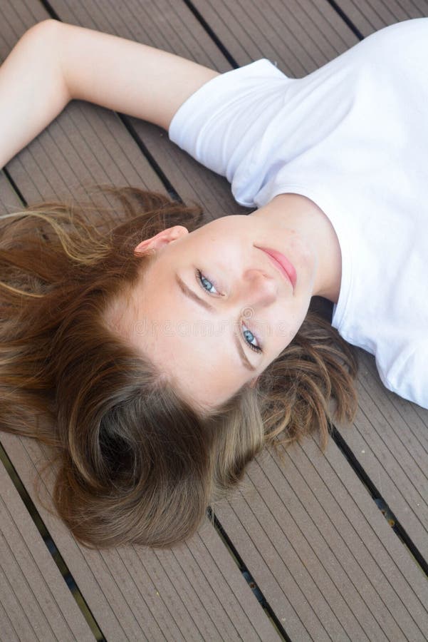 Female teenager smiling, layingon the floor. Summer, portrait of young girl with long blonde hair, have, fun, joy, happy, smile, education, holidaays, vacation, school, beautiful, cute, sfashion, copy, space, hand, child, person, kid, face, pretty, youth, attractive, expression, eyes, model, healthy, fresh, natural, people, tshirt, headshot, sixteen, adolescent, look. Female teenager smiling, layingon the floor. Summer, portrait of young girl with long blonde hair, have, fun, joy, happy, smile, education, holidaays, vacation, school, beautiful, cute, sfashion, copy, space, hand, child, person, kid, face, pretty, youth, attractive, expression, eyes, model, healthy, fresh, natural, people, tshirt, headshot, sixteen, adolescent, look