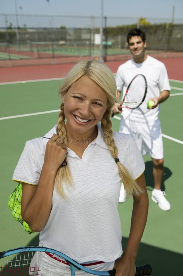 Female Tennis Player At Net On Tennis Court Portrait Stock Image