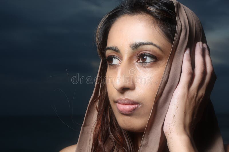 Young Bangladeshi woman touching her head. Young Bangladeshi woman touching her head