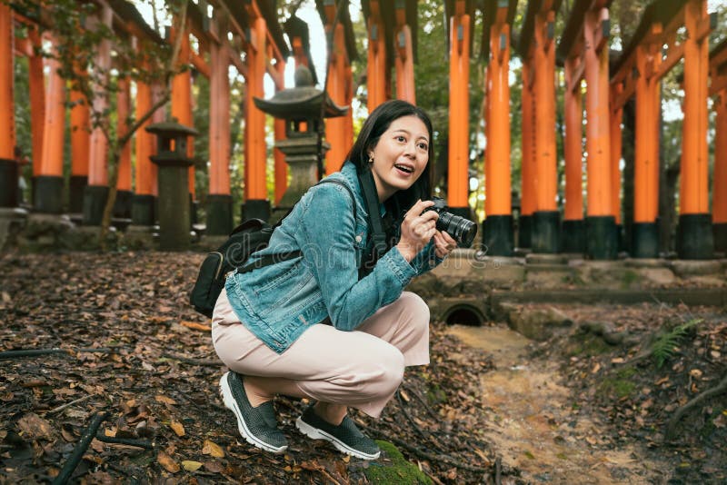 Female tourist kneel down taking picture royalty free stock photography
