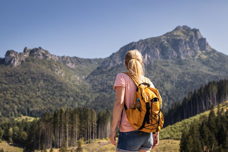 Female tourist looking at rocky mountain know as Velky Rozsutec in Mala Fatra, Slovakia