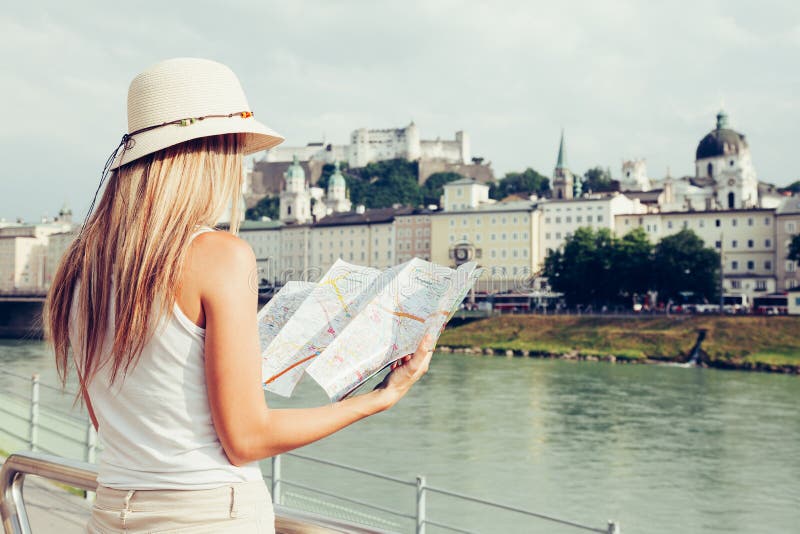 Female tourist on vacation in Salzburg Austria holding a local map stock photo Female tourist on vacation in Salzburg Austria holding a local map stock photo