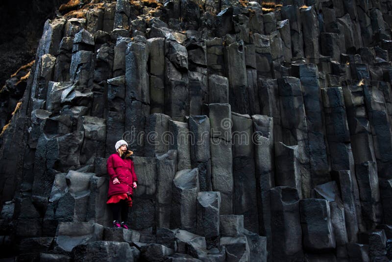 Female traveler on rocks of Black sand Reynisfjara Beach in Iceland royalty free stock photo Female traveler on rocks of Black sand Reynisfjara Beach in Iceland royalty free stock photo