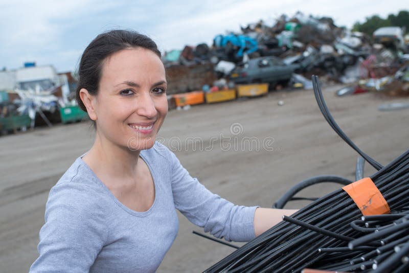 Female using crane with rubbish car scrapyard stock photos Female using crane with rubbish car scrapyard stock photos