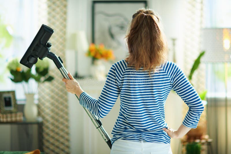 Female with Vacuum Cleaner in Living Room in Sunny Day Stock Image ...