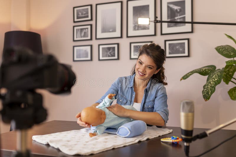 Female Vlogger Making Video about Newborn Baby Handling Stock Image 