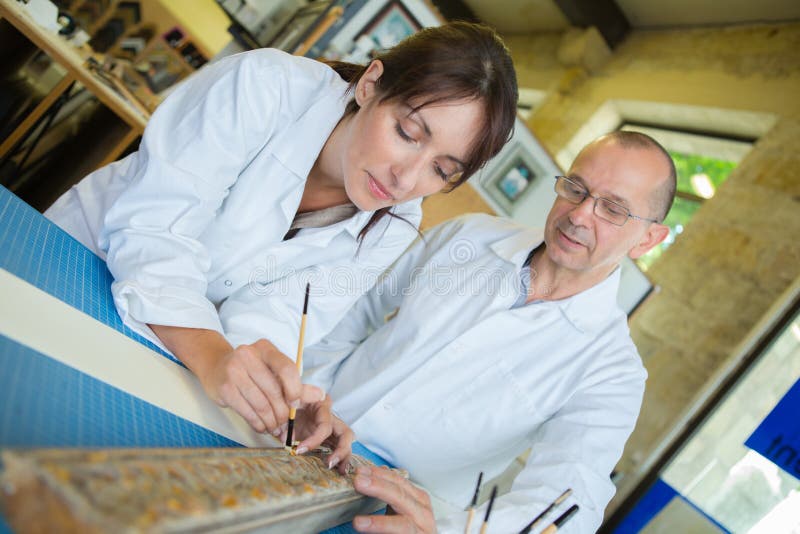Female worker measure frame in workshop stock photography Female worker measure frame in workshop stock photography