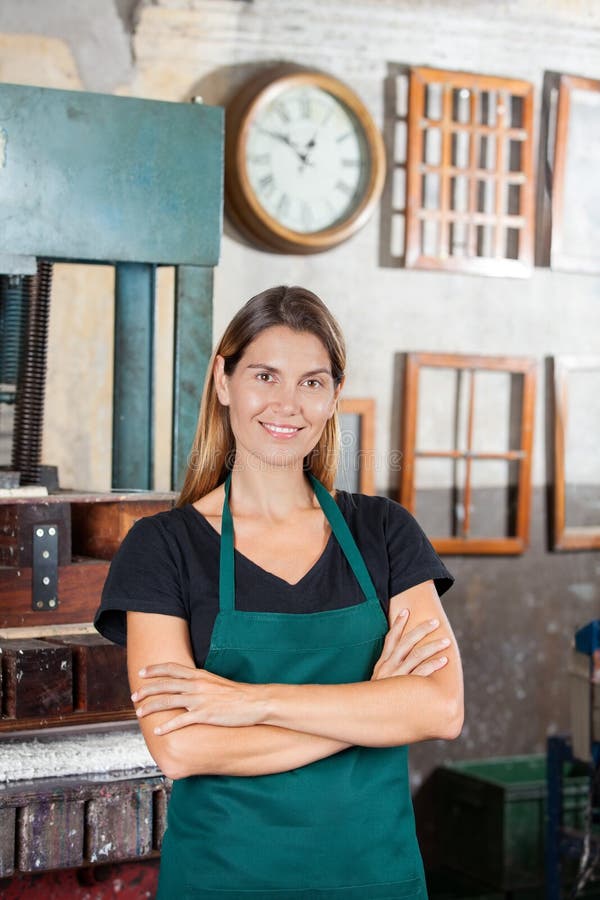 Female Worker Standing Arms Crossed In Paper royalty free stock photo Female Worker Standing Arms Crossed In Paper royalty free stock photo