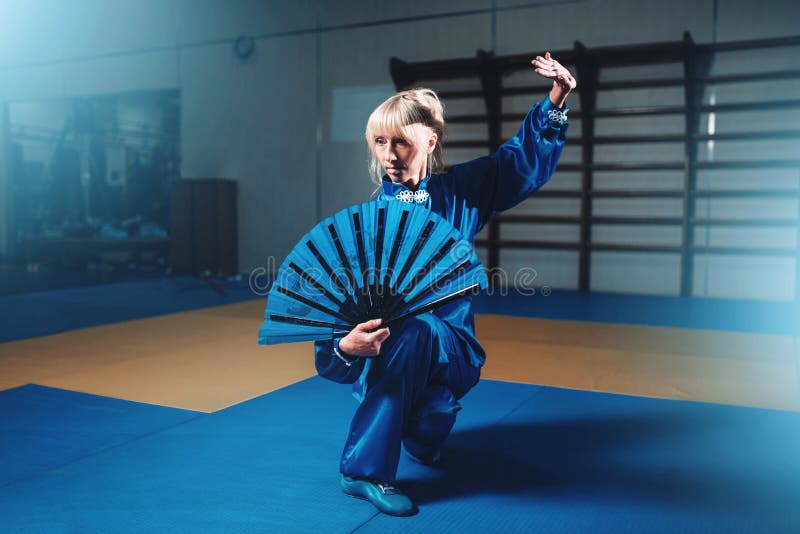 Female wushu master with fan, martial arts