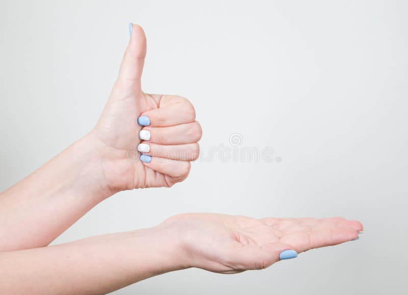 Female young hand in likeness gesture with thumb up isolated. Closeup view of female young hand in likeness gesture with thumb up isolated on white background stock photos Female young hand in likeness gesture with thumb up isolated. Closeup view of female young hand in likeness gesture with thumb up isolated on white background stock photos